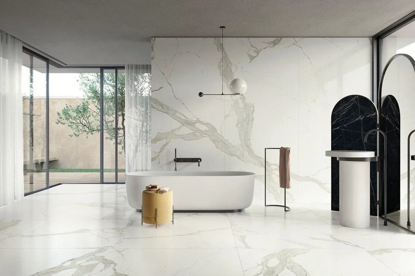 A bathroom with marble walls and floors, and a tub.