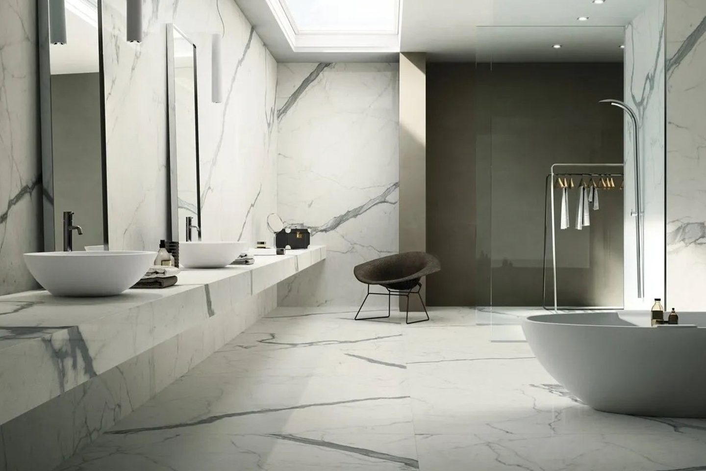 A bathroom with white marble walls and floors.